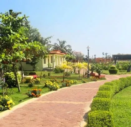 A beautifully landscaped park with winding brick pathways, neatly trimmed hedges, and colorful flower beds. This is an example of our public space design, focusing on creating enjoyable and accessible green areas.