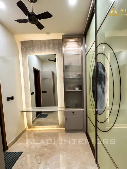 A dressing area with a unique wardrobe design. The sliding doors feature a large circular graphic, adding an artistic and personalized touch to the room.