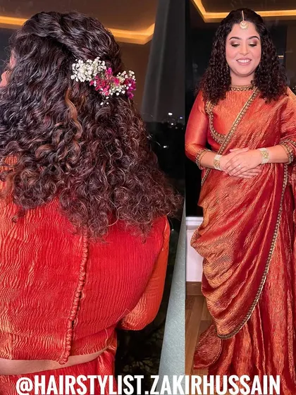 A half-up style for naturally curly hair, enhanced with a simple twist and a floral accessory. This shows how I work with and enhance a client's natural texture.