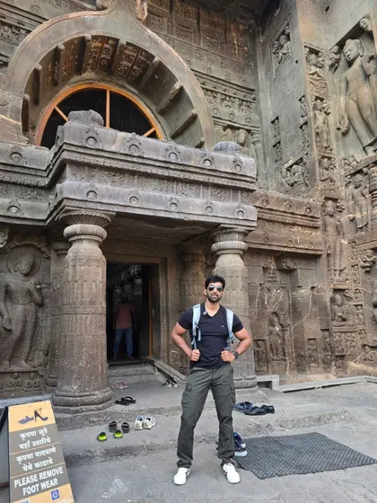 Standing at the entrance of one of the magnificent rock-cut caves at Ellora.