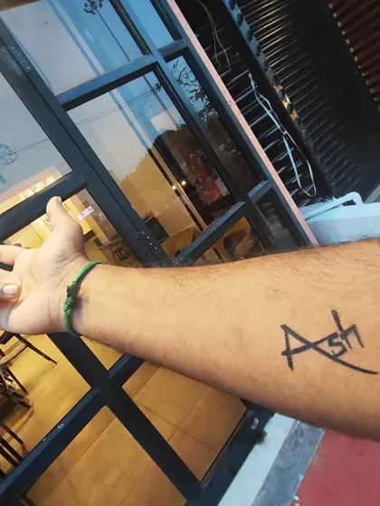 A simple and stylish custom name tattoo. I can create a unique font design like this one for you in just a minute. It's a popular choice for people who want to try out a name design before committing to a permanent one.