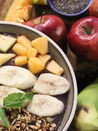 Another angle of our smoothie bowl, highlighting the fresh apples and raw bananas that form the base of this delicious and healthy meal.
