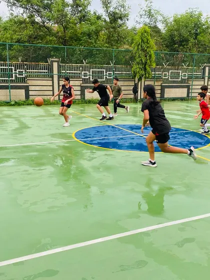 Players running a drill, splashing through puddles with enthusiasm.