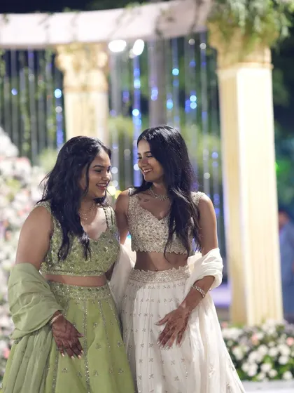 A candid moment between two sisters, both dressed in our curated lehengas. It’s these shared moments of joy and celebration that we love to be a part of.
