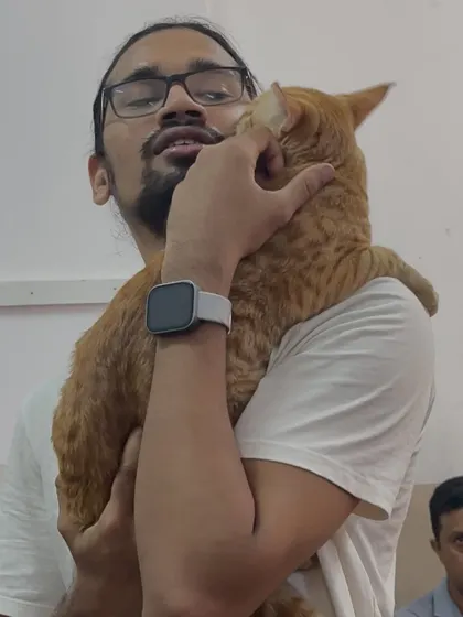 A visitor shares a sweet moment with a friendly ginger cat. You can see the trust and affection in this interaction.