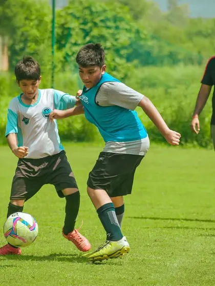 A corner tussle with a coach looking on.
