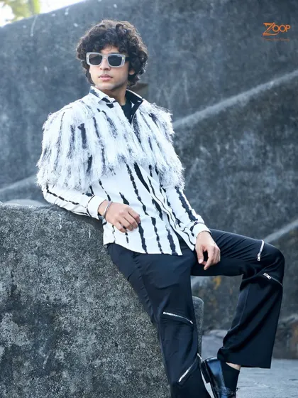 Another angle of our edgy fringe shirt. This piece is crafted from breathable fabric, making it a perfect example of summer sophistication with a rebellious spirit.