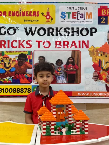 A student presents his intricate LEGO temple model, a project from our cultural building series.