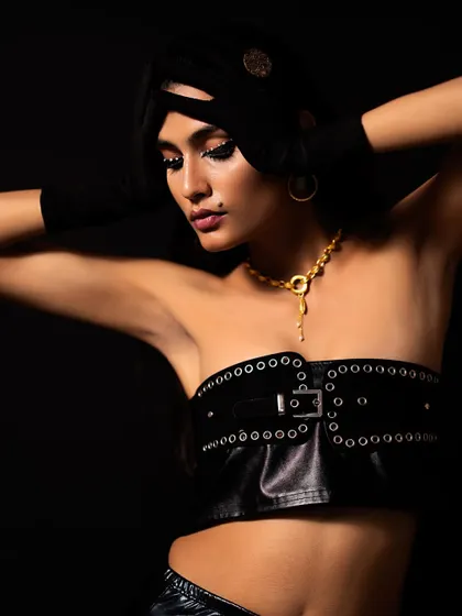 A "Jet Black Vibes" concept shoot I directed and styled. I used a black-on-black theme with a leather corset, turban, and dramatic, crystal-studded eye makeup to create a powerful and mysterious editorial look.
