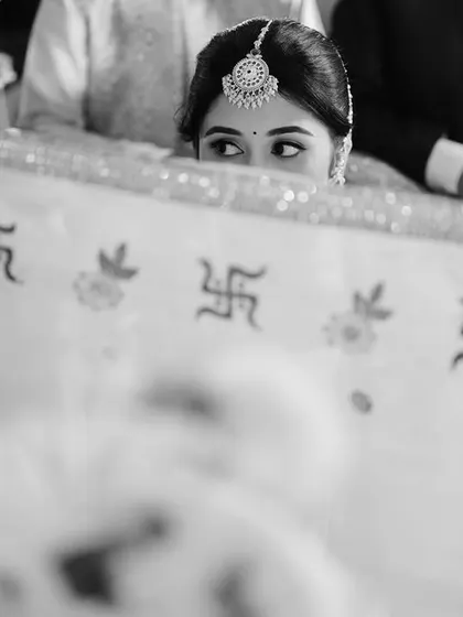 A peek-a-boo moment during the ceremony. This creative shot from behind the antarpat captures the bride's anticipation and excitement.