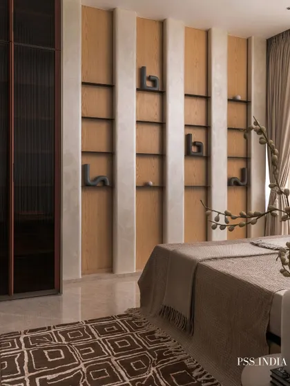 This bedroom showcases the art of layering textures for depth. A sculptural wave detail on the wall, an embossed leather headboard, and a mix of textiles on the bed create a rich, inviting, and tactile experience.