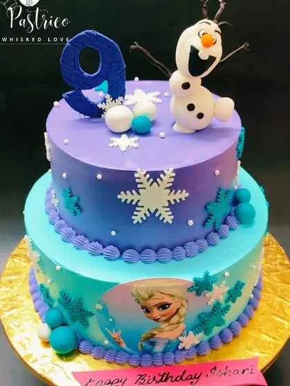 A two-tiered Frozen cake in shades of purple and blue, with an edible print of Elsa and a handcrafted Olaf on top.