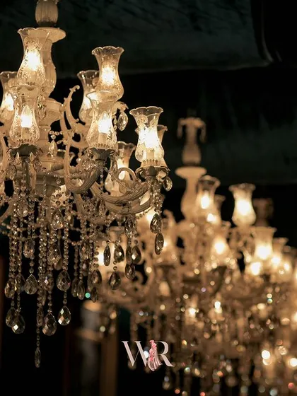 A detail shot of the classic crystal chandeliers, a signature element in our luxury decor. Their timeless design adds a touch of elegance and sparkle to any setting.