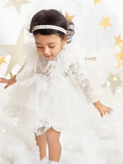 Walking on clouds. This photo captures a precious moment of a little one taking her first steps among the stars.