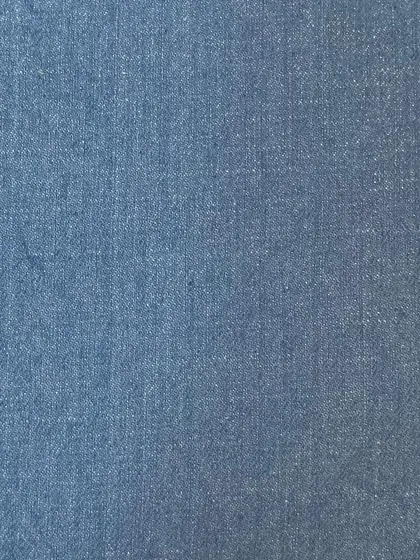 A swatch of light blue chambray-like denim. This lightweight fabric is perfect for comfortable summer jeans or a custom denim shirt.