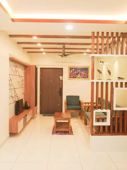 A spacious and traditional living room with a wooden rafter partition that creates a beautiful visual separation. The design emphasizes natural wood tones and a comfortable, open layout.