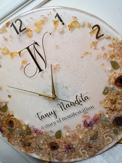 An angled view of the custom resin clock, highlighting the depth and the way the light catches the gold flakes and glossy surface.