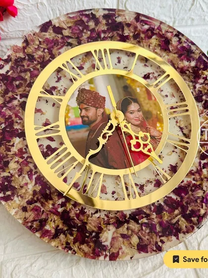 This 12-inch resin wall clock features a couple's photo at its center, surrounded by preserved varmala petals. The golden dial adds a classic touch to this wedding keepsake.