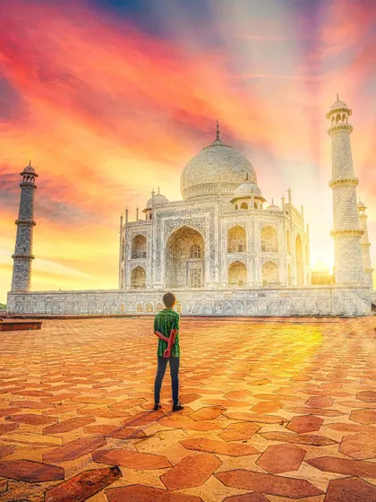 This is a travel portrait that tells a story. By placing the subject within the grand scene of a Taj Mahal sunset, the image becomes about a personal moment of awe, enhanced by a vibrant, cinematic edit.