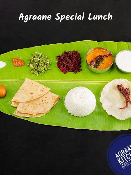 This is our Agraane Special Lunch, a complete Brahmin-style meal served on a traditional banana leaf. It includes chapati, white rice, sambar, a vegetable stir-fry (palya), kosambari, pickle, curd, and a sweet, giving you the authentic taste of a home-cooked feast.