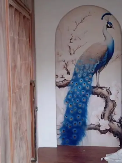 A beautifully painted peacock mural designed to fit perfectly within an arched wall niche, turning an architectural feature into a piece of art.