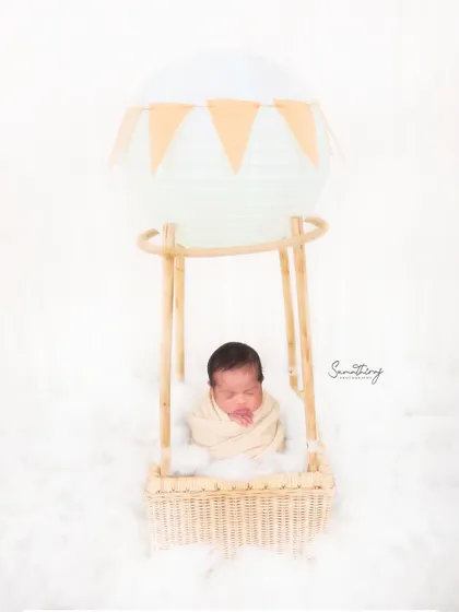 Up, up, and away! This hot air balloon setup is one of my most requested themes. With a clean white background and soft textures, it creates a whimsical and adventurous portrait while your little one is safely nestled in the basket.