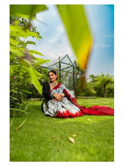 A different angle from the same garden shoot, this image uses a foreground element to create depth and a sense of peeking into a private, happy moment.