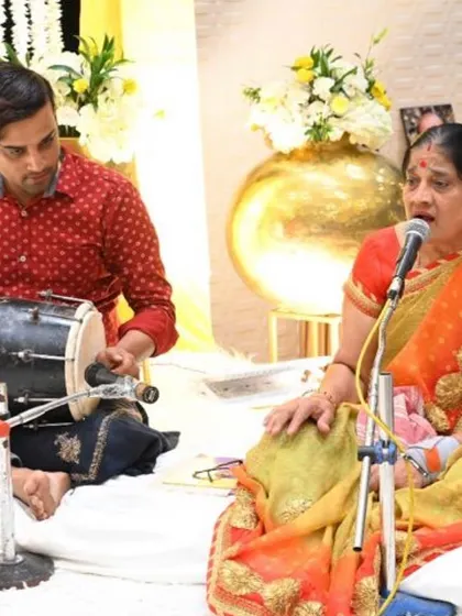 Entertainment is key for a lively Mehendi. Here, a dholak player and a folk singer entertain the guests, creating a traditional and celebratory atmosphere.
