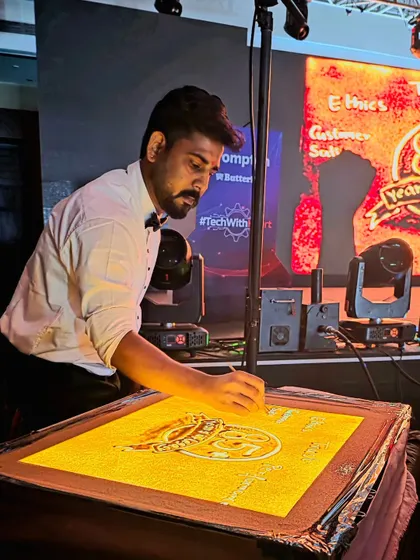 A focused moment during the live performance for Crompton. Every grain of sand is carefully placed to build the narrative and create a visually stunning experience for the audience.