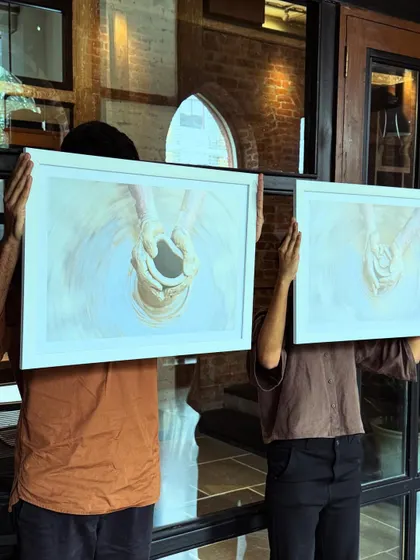 Faces, expressions, moments. Team members holding up artwork, a playful moment at The Loft.