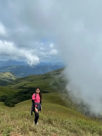 Another shot of a trekker enjoying the magnificent views as clouds roll in over the valley.
