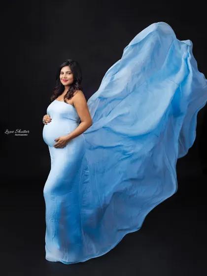 Embracing new beginnings in this light blue gown. The tossing fabric creates a sense of freedom and grace.