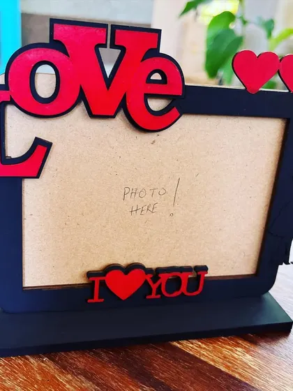 This handcrafted "LOVE" themed photo frame is perfect for a desk or bedside table. It has a dedicated space for a special photo and serves as a constant reminder of a cherished relationship.