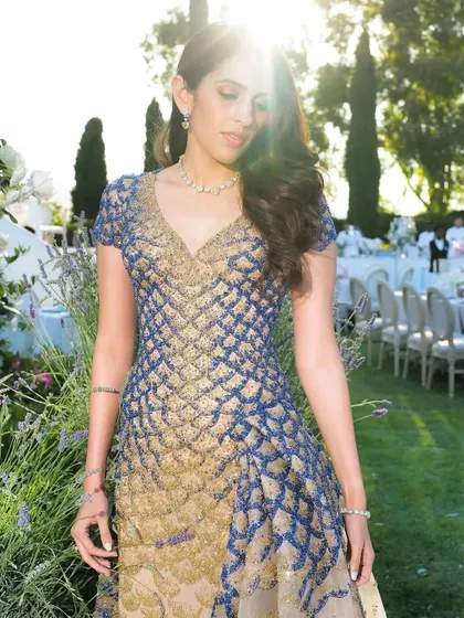 The soft, sun-kissed lighting brings out the golden tones in the Versace gown. Part of my job is ensuring the final look is perfect for the setting and the photography.