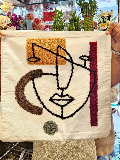 This abstract face cushion cover is a piece of art for your sofa. The tufted embroidery adds a unique texture and a modern, artistic flair to your living room.