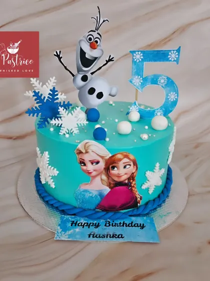 Let it go with this beautiful Frozen-themed cake, featuring an edible print of Anna and Elsa, topped with a handmade fondant Olaf.