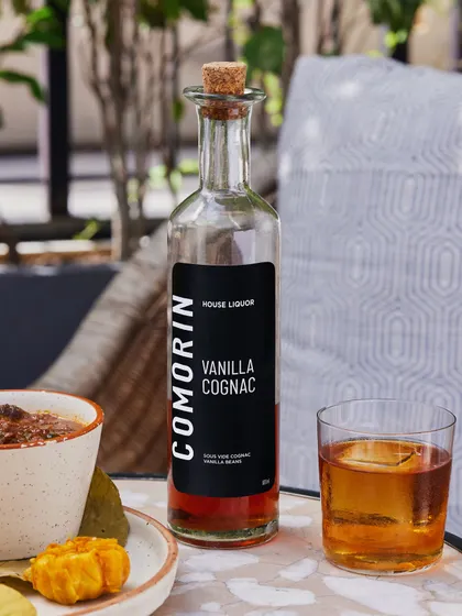 A bottle of our Vanilla Cognac, a unique house liquor you can enjoy at our bar.