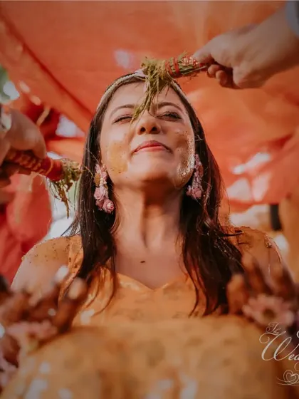 A traditional ritual during the Haldi ceremony, a moment of blessings and joy.