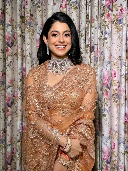 The complete look. A sparkling saree, a diamond choker, and timeless makeup create a picture of royal glamour.