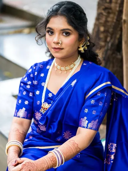 A closer look at the engagement styling. The simple pearl necklace beautifully complements the royal blue Nauvari and the bride's soft, glowing makeup.