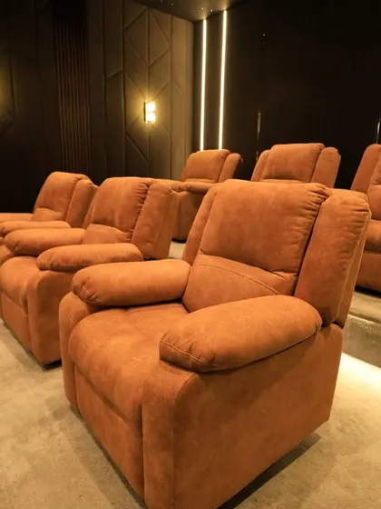 The tiered seating arrangement in this Pudukottai theater ensures that all seven seats have a clear, unobstructed view of the screen.