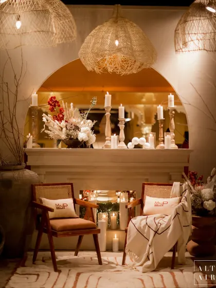 A cozy corner at the 'Muted Melodies' sangeet, complete with a fireplace, personalized cushions, and soft candlelight. Every detail was curated to create a symphony of harmony and cohesion.