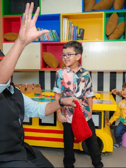 A young boy watches with a smile as the magician performs a trick just for him.