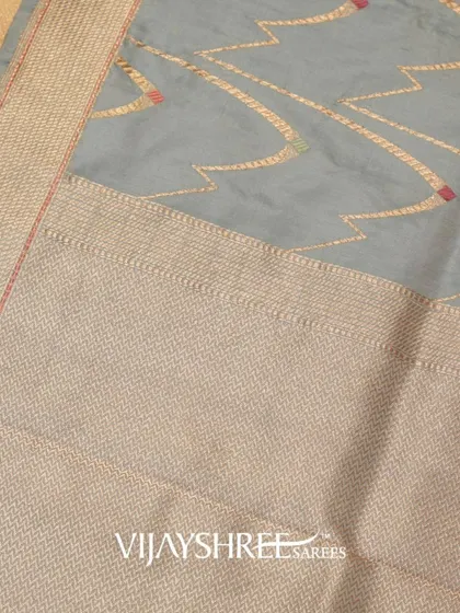 A close-up of the unique, modern pattern on the grey Banarasi saree.