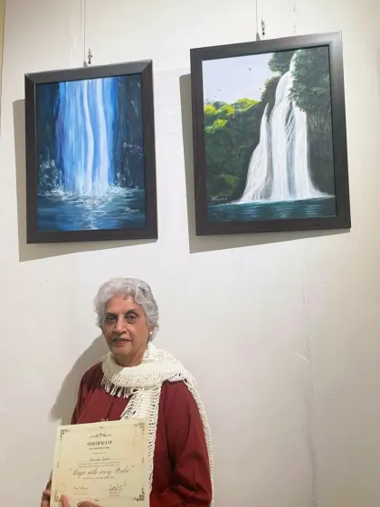 A truly proud moment for us and our student. Harinder ma'am receiving her participation certificate at the 'Magic with Every Stroke' exhibition for her beautiful waterfall paintings.