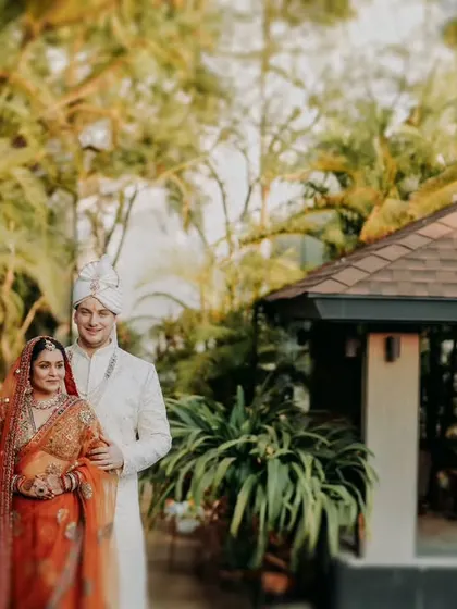 A classic portrait of the couple in a lush, green setting, demonstrating our ability to find beautiful light and composition in any environment.