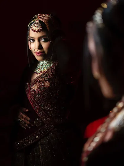 A beautiful mirror portrait where the bride looks back at the camera, creating a compelling and engaging image.