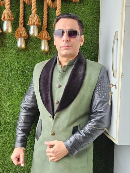 Another view of the unique olive green and black Indo-Western jacket, showing its distinctive design.