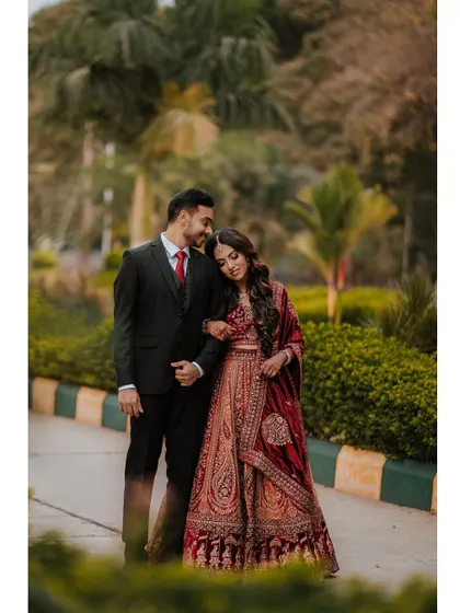 A romantic portrait of Sushmita and Deepak during their reception, set in a beautiful garden.
