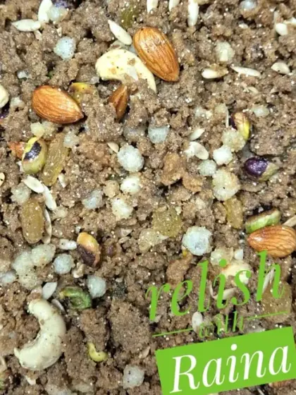 A close-up of the Panjiri, showing the mix of roasted flour, puffed gond, and whole nuts like almonds and cashews. It is as delicious as it is nutritious.